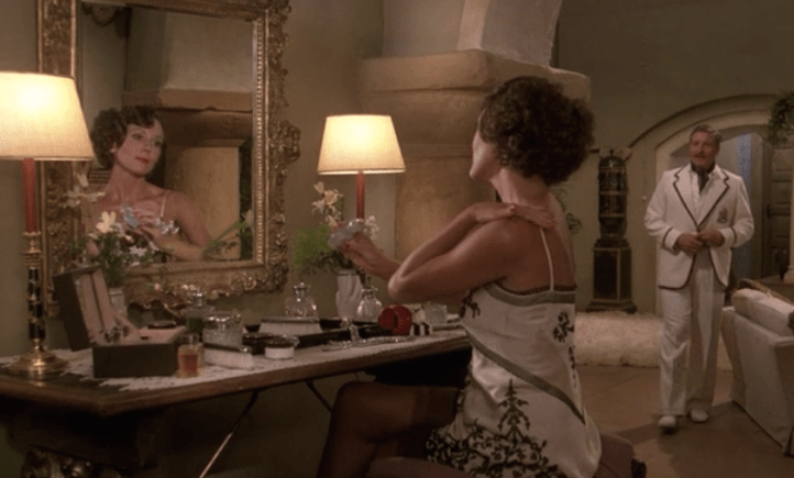 diana rigg at dressing table.png